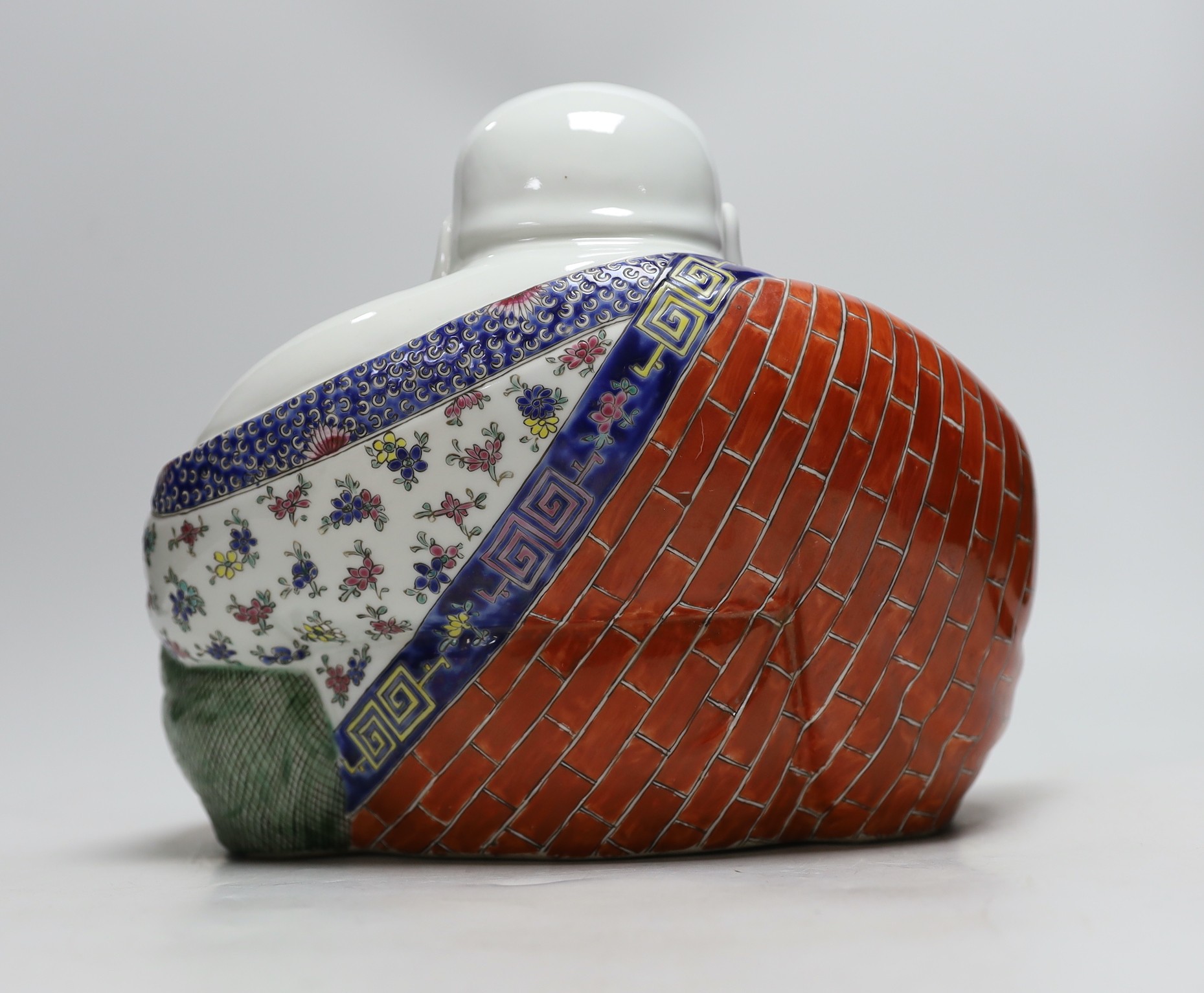 A Chinese famille rose figure of Budai, 23cm tall